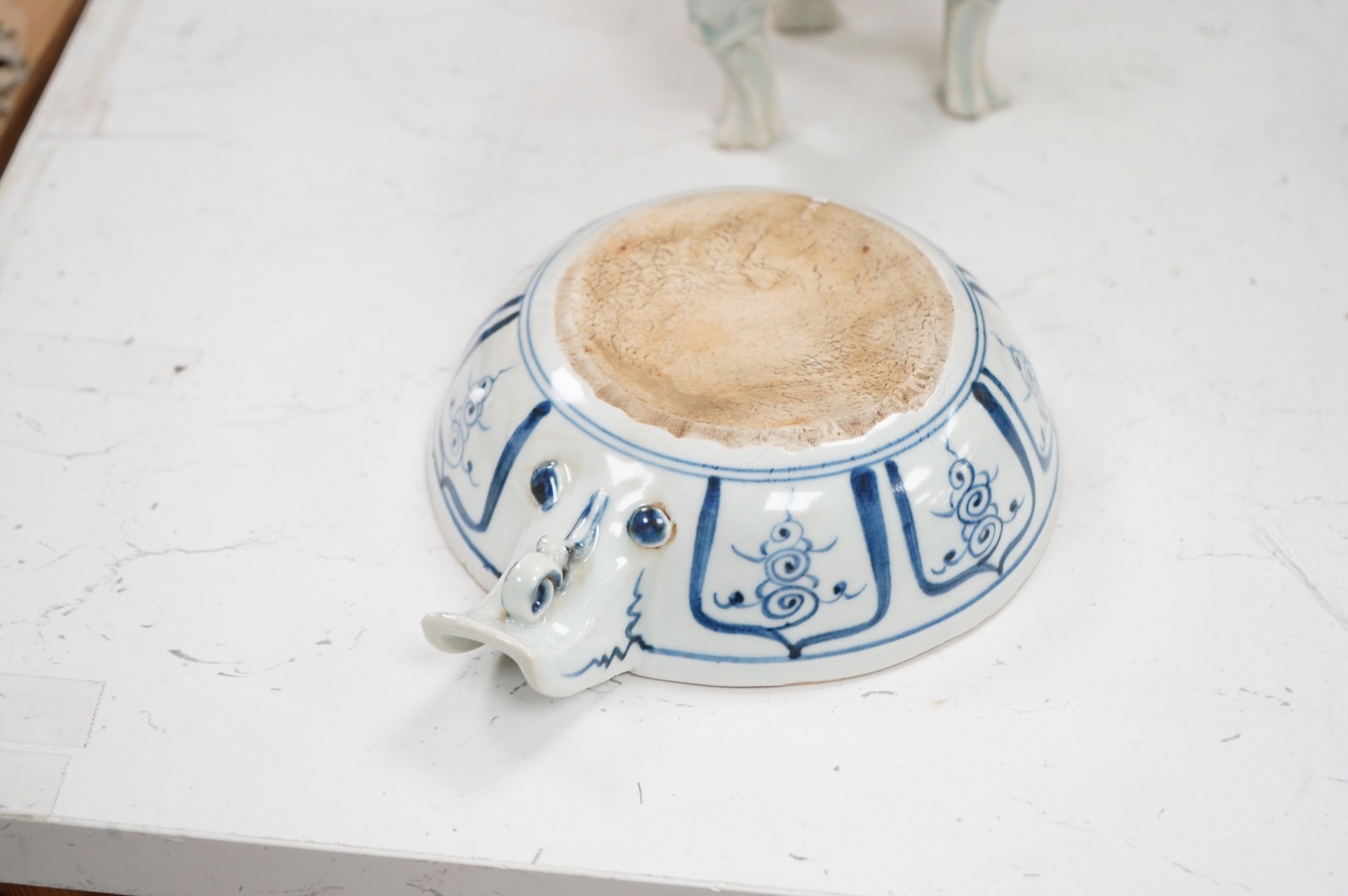 A Chinese three footed censer and a blue and white pouring bowl, largest 15cm high